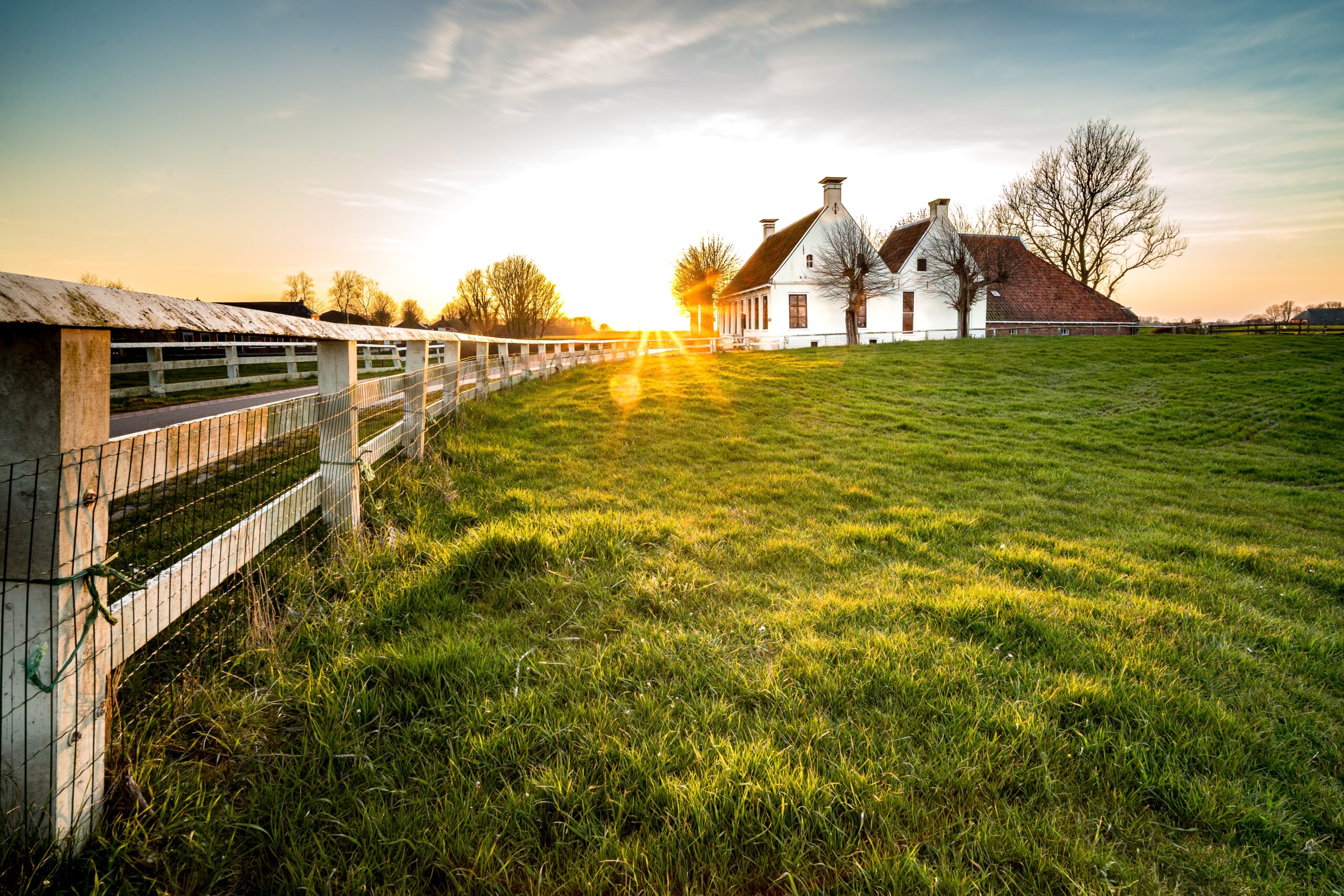 beautiful shot fence leading house green grass area scaled